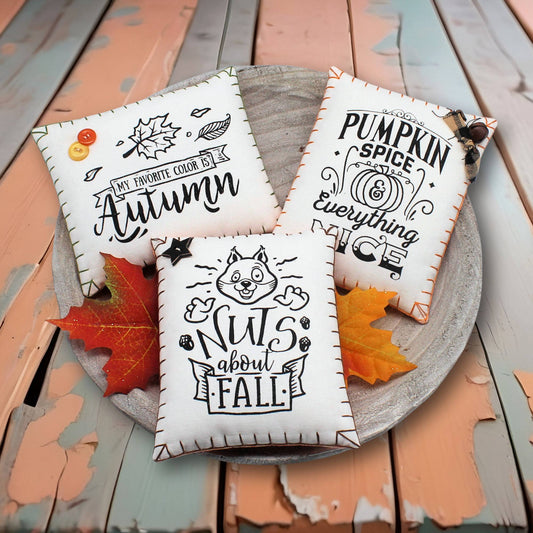 Set of three mini pillow bowl fillers screen-printed with autumn designs on white cotton