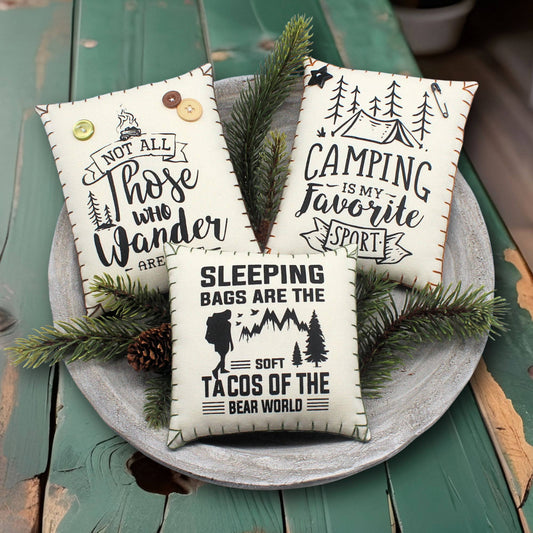 Set of three screen-printed mini pillows with adventure-themed designs for camping or cabin decorating