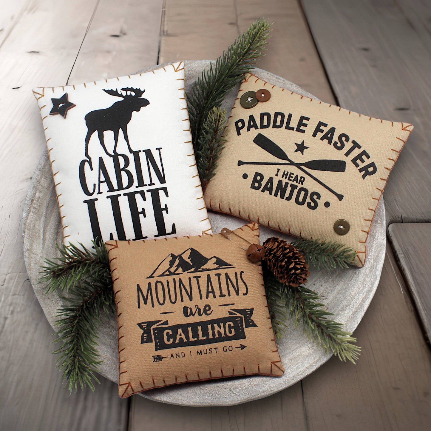 Set of three mini pillow bowl fillers with cabin and mountain-themed text and graphics