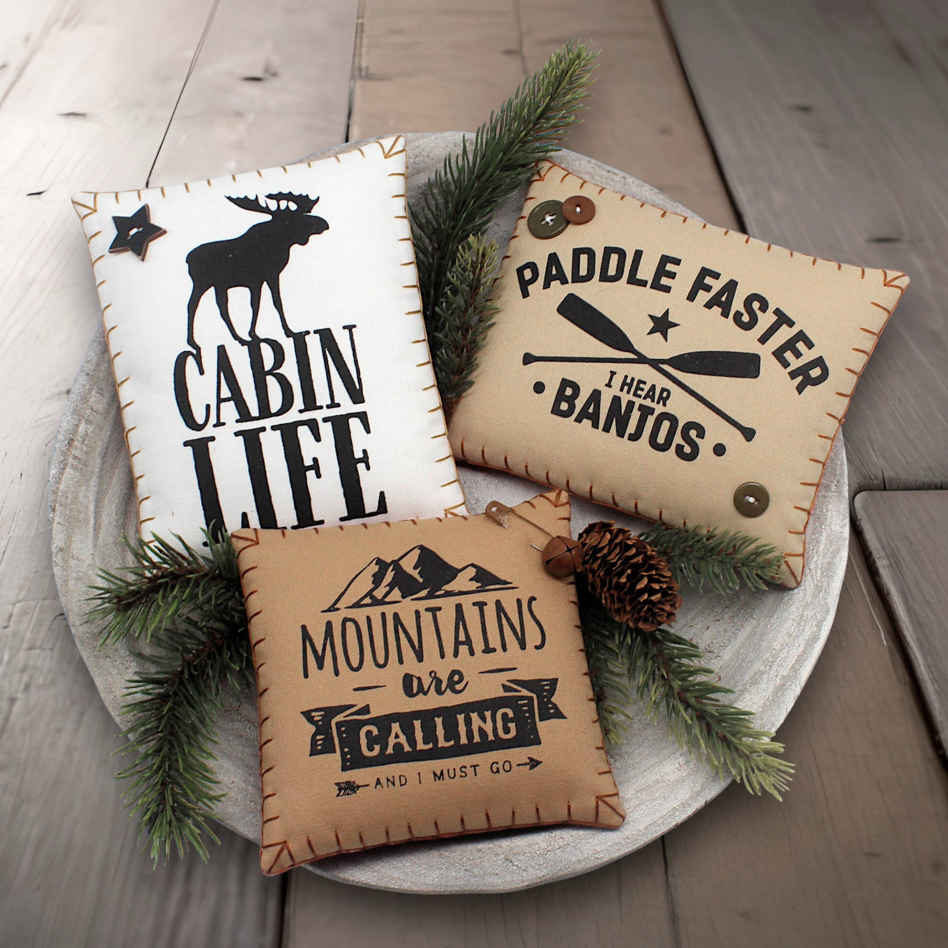 Set of three mini pillow bowl fillers with cabin and mountain-themed text and graphics
