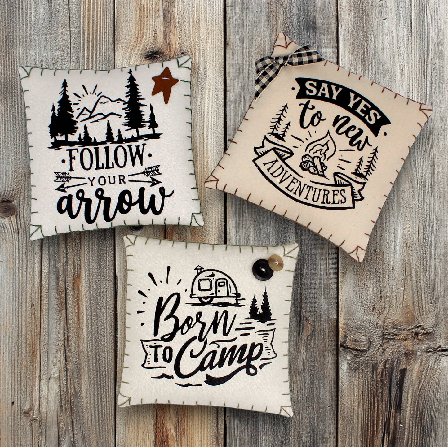 Set of three mini pillow bowl fillers with camping and adventure-themed text and graphics