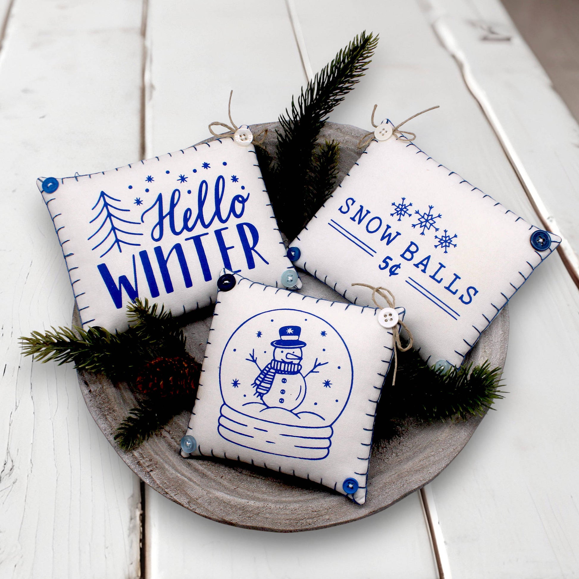 Set of three mini pillow bowl fillers with snowman and winter-themed text and graphics