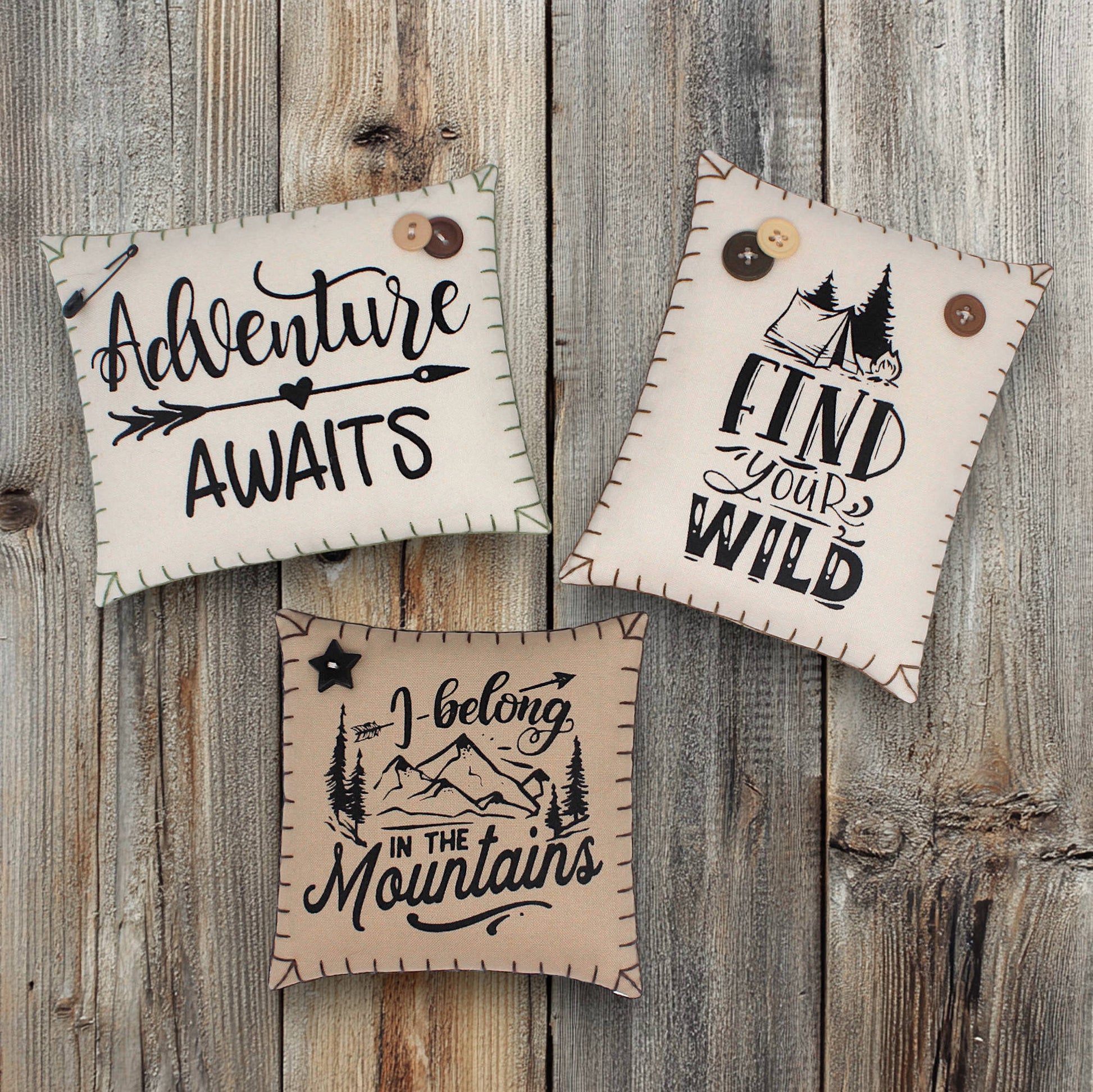 Set of three mini pillow bowl fillers with mountain cabin and adventure-themed text and graphics
