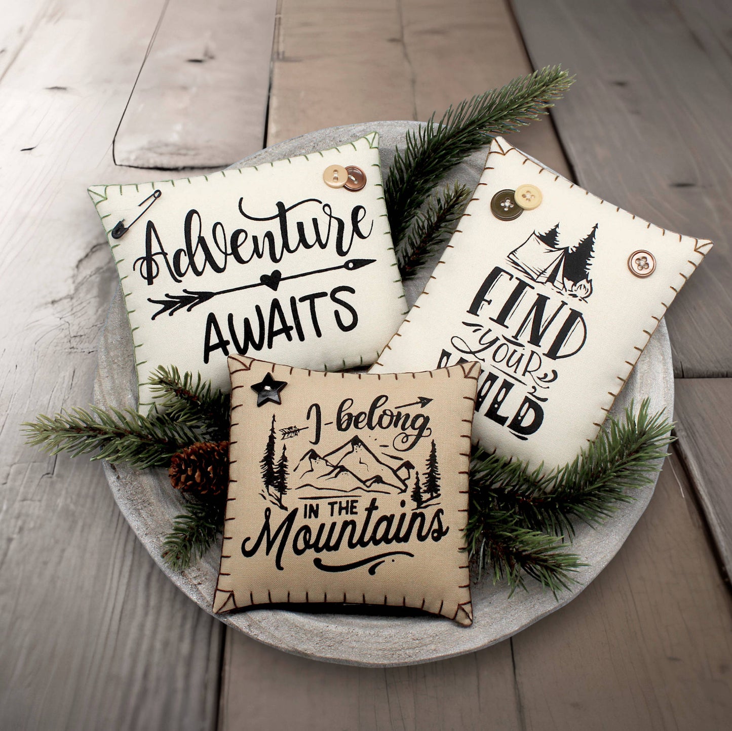 Set of three mini pillow bowl fillers with mountain cabin and adventure-themed text and graphics