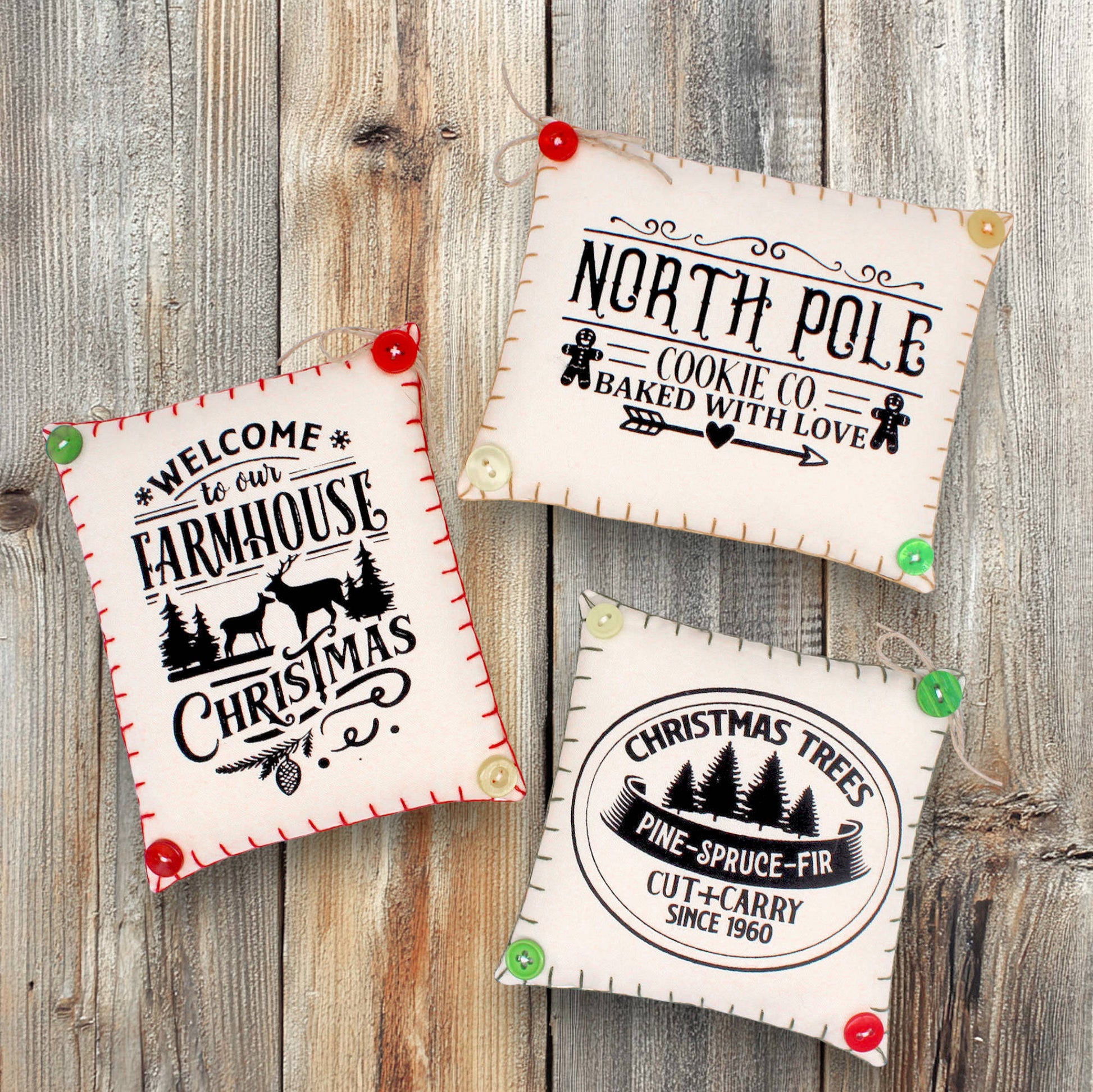 Set of three mini pillow bowl fillers with screen-printed Christmas text and graphics