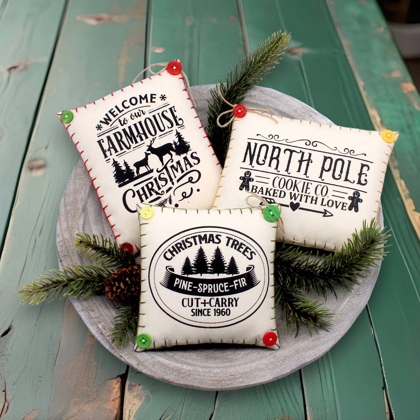 Set of three mini pillow bowl fillers with screen-printed Christmas text and graphics