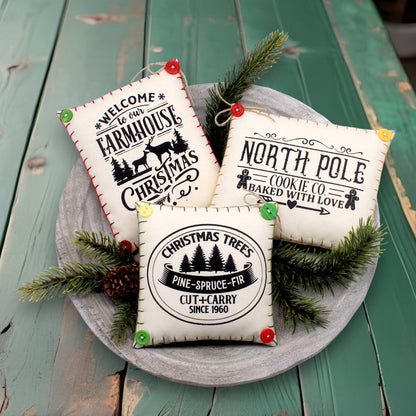 Set of three mini pillow bowl fillers with screen-printed Christmas text and graphics