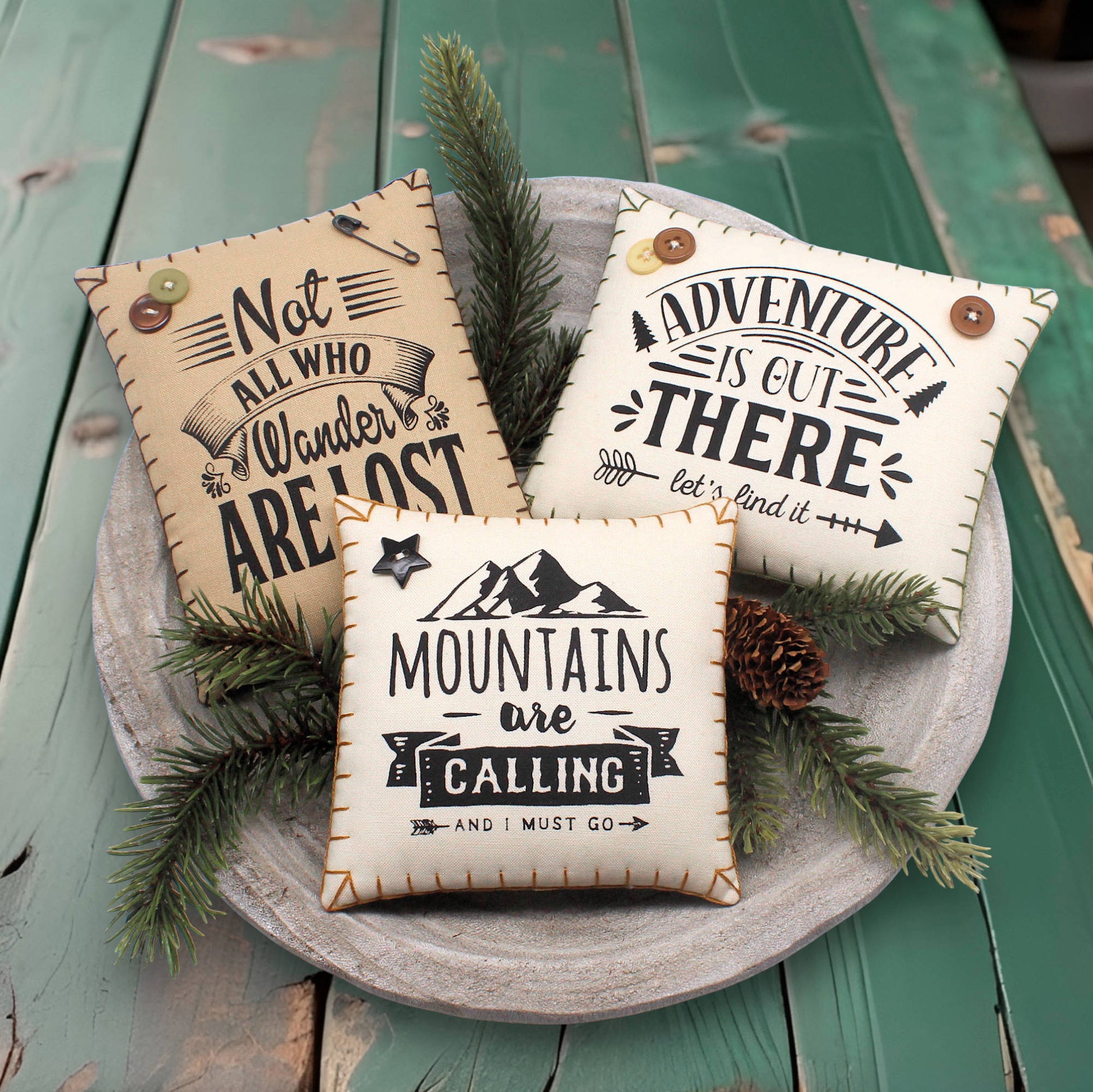 Set of three mini pillow bowl fillers with mountain and adventure-themed text and designs