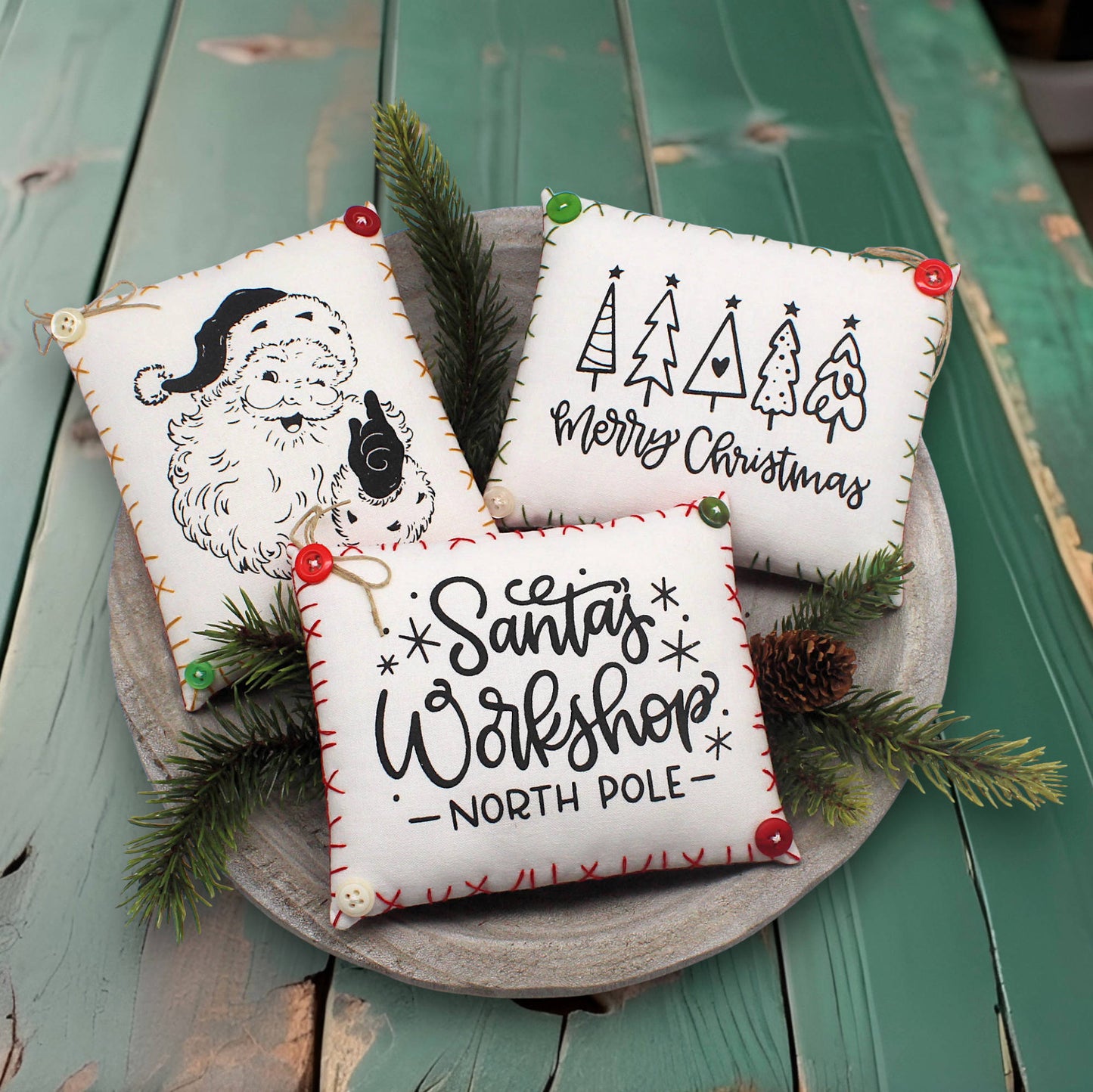 Set of three screen-printed mini pillow bowl fillers with Christmas themed text and designs