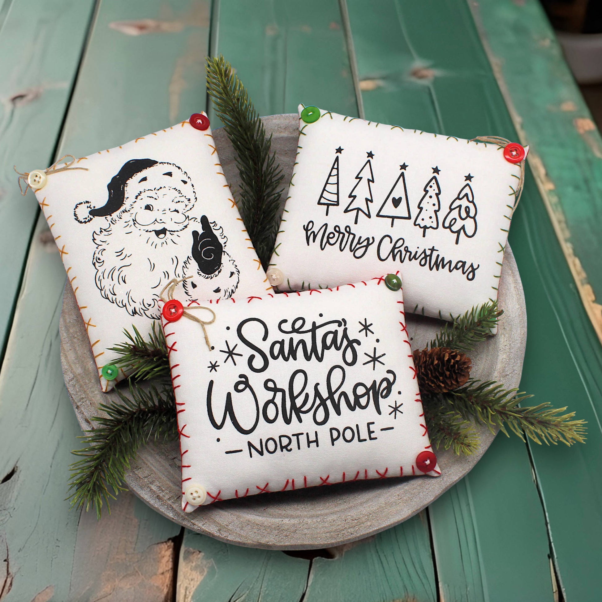 Set of three screen-printed mini pillow bowl fillers with Christmas themed text and designs