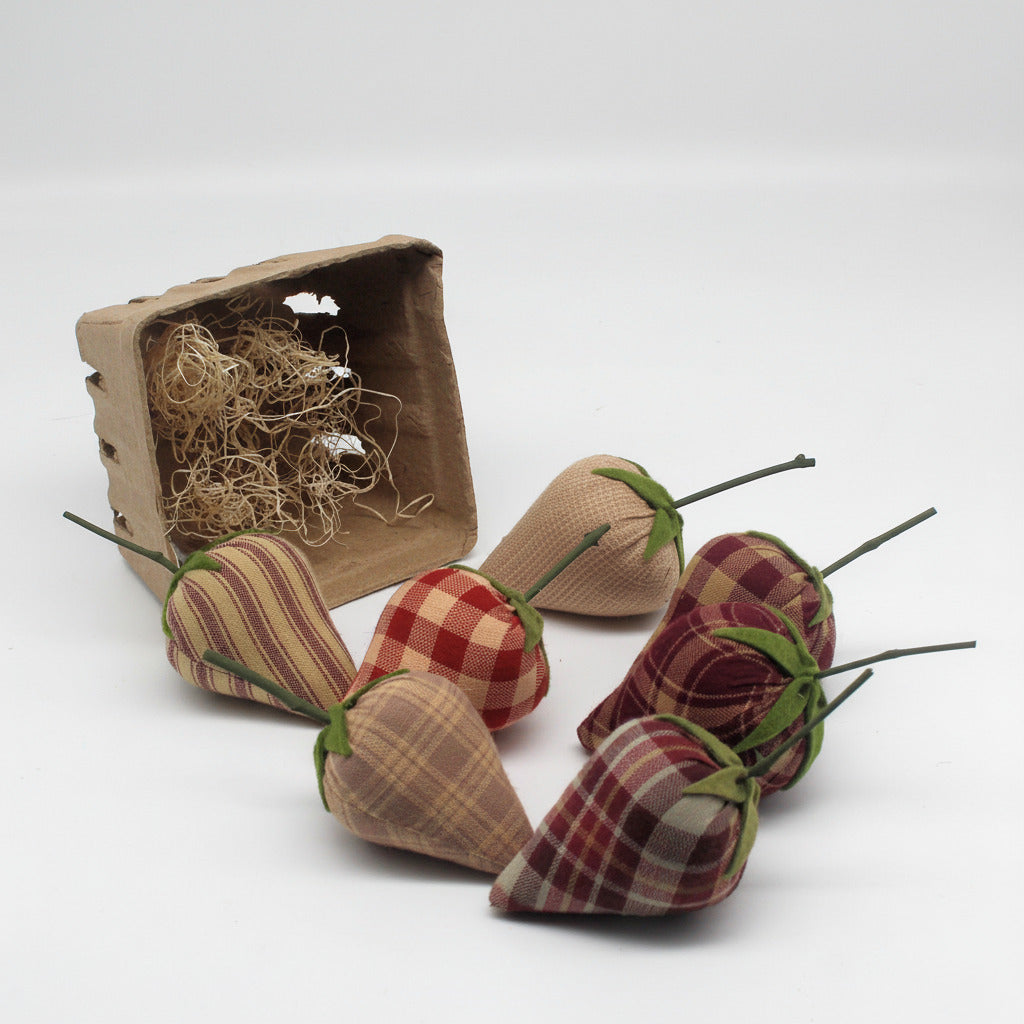 Fabric strawberries with plaid patterns and green stems on a white background