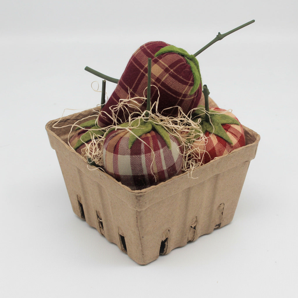 Fabric strawberries in a cardboard basket on a white background