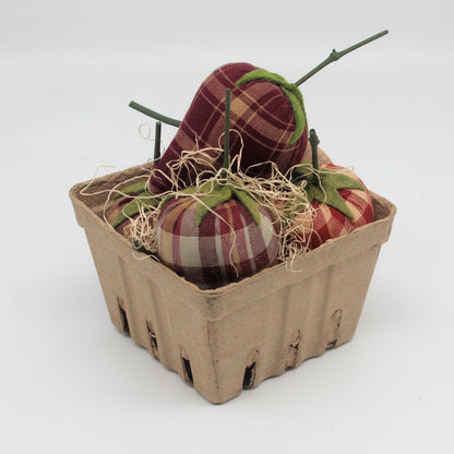 Fabric strawberries in a cardboard basket on a white background