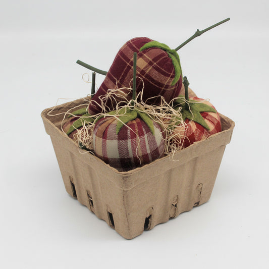 Fabric strawberries in a cardboard basket on a white background