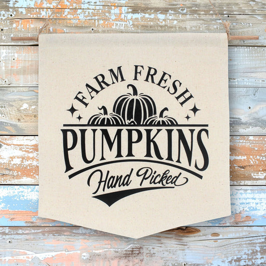 Canvas banner with 'Farm Fresh Pumpkins Hand Picked' text and pumpkin graphics on a wooden background