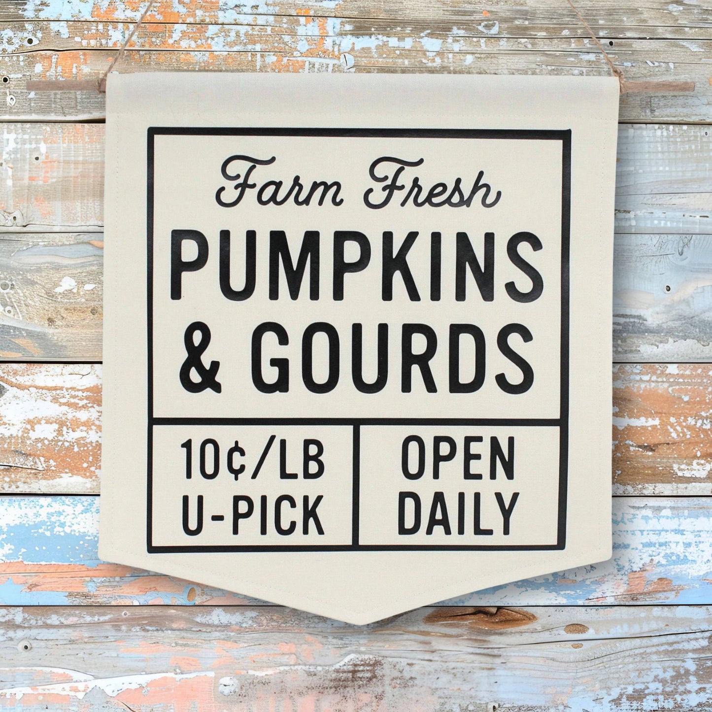 Canvas sign with 'Farm Fresh Pumpkins & Gourds' text on a wooden background