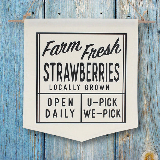 Farm fresh strawberries locally grown sign on a wooden background
