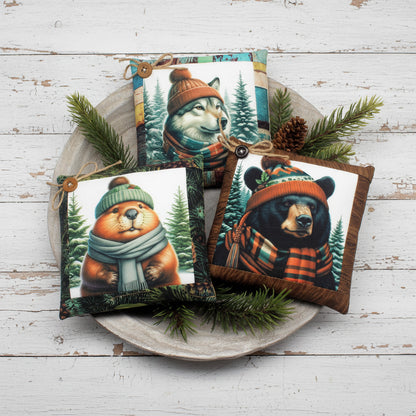 Decorative pillows with animal designs wearing hats and scarves on a white background