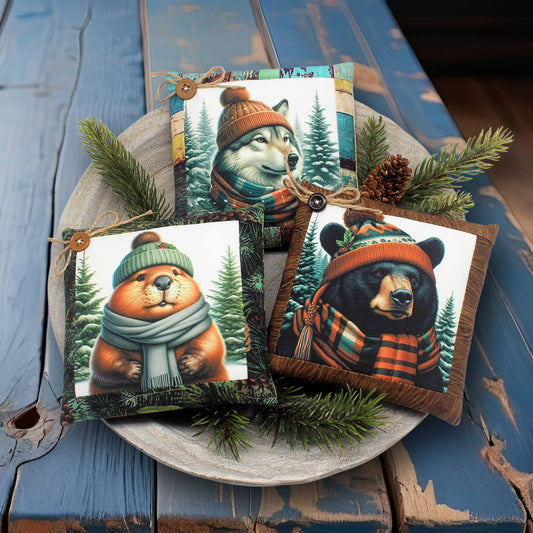 Four animal-themed mini pillow bowl fillers with winter accessories on a wooden surface
