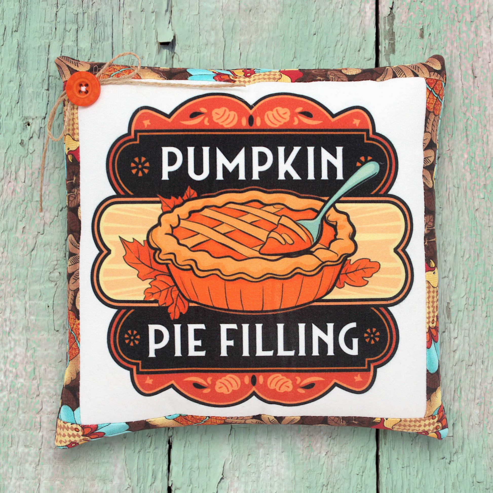 Small decorative pillow with a colorful pumpkin pie filling design