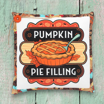 Small decorative pillow with a colorful pumpkin pie filling design