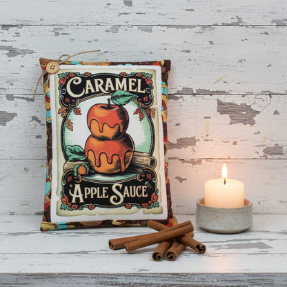 Vintage-style label for caramel apple sauce with an apple illustration on a wooden surface.