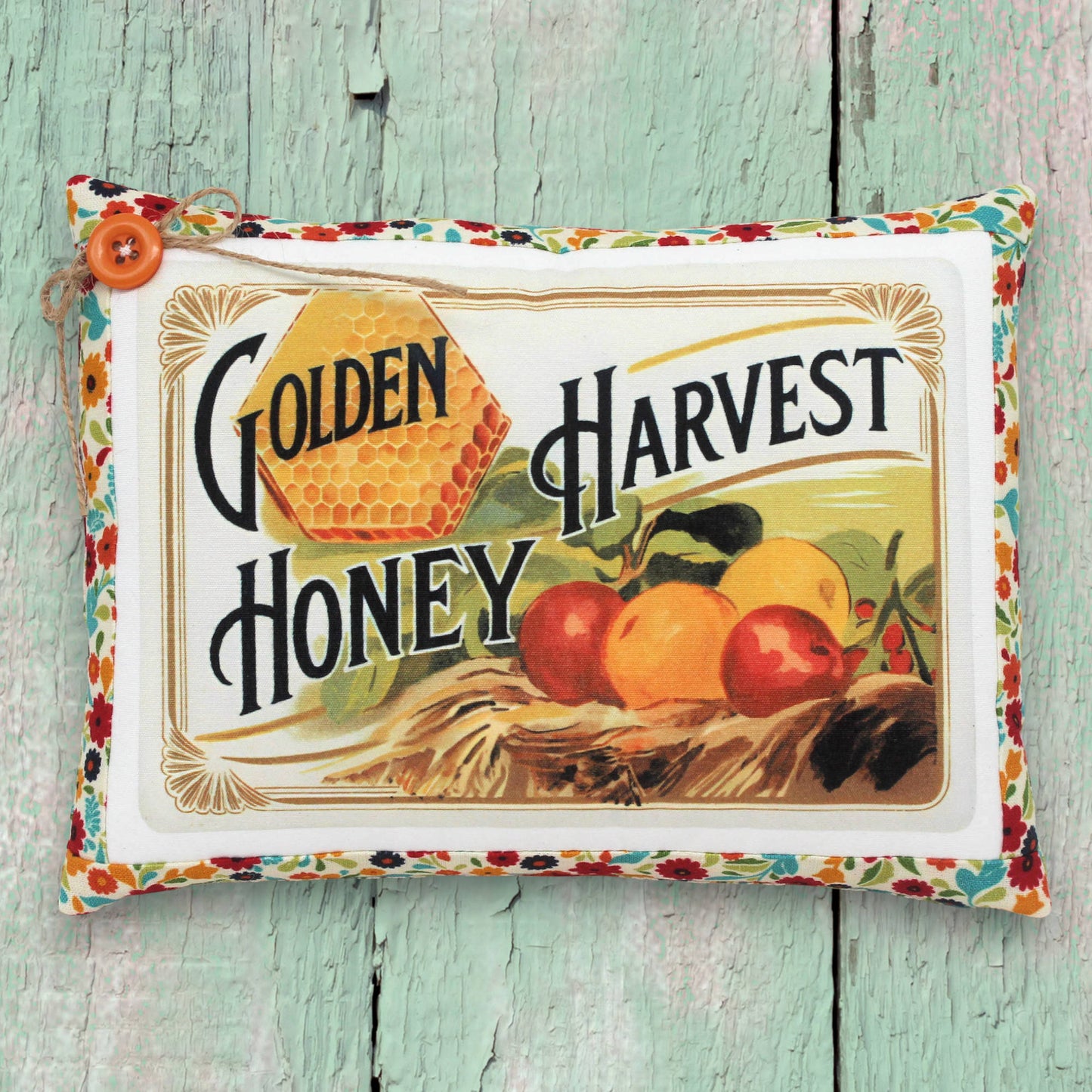 Small decorative pillow featuring a colorful golden harvest honey design