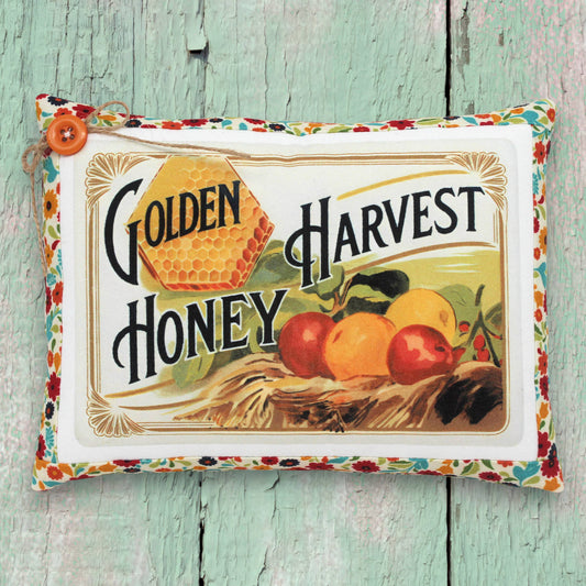 Small decorative pillow featuring a colorful golden harvest honey design