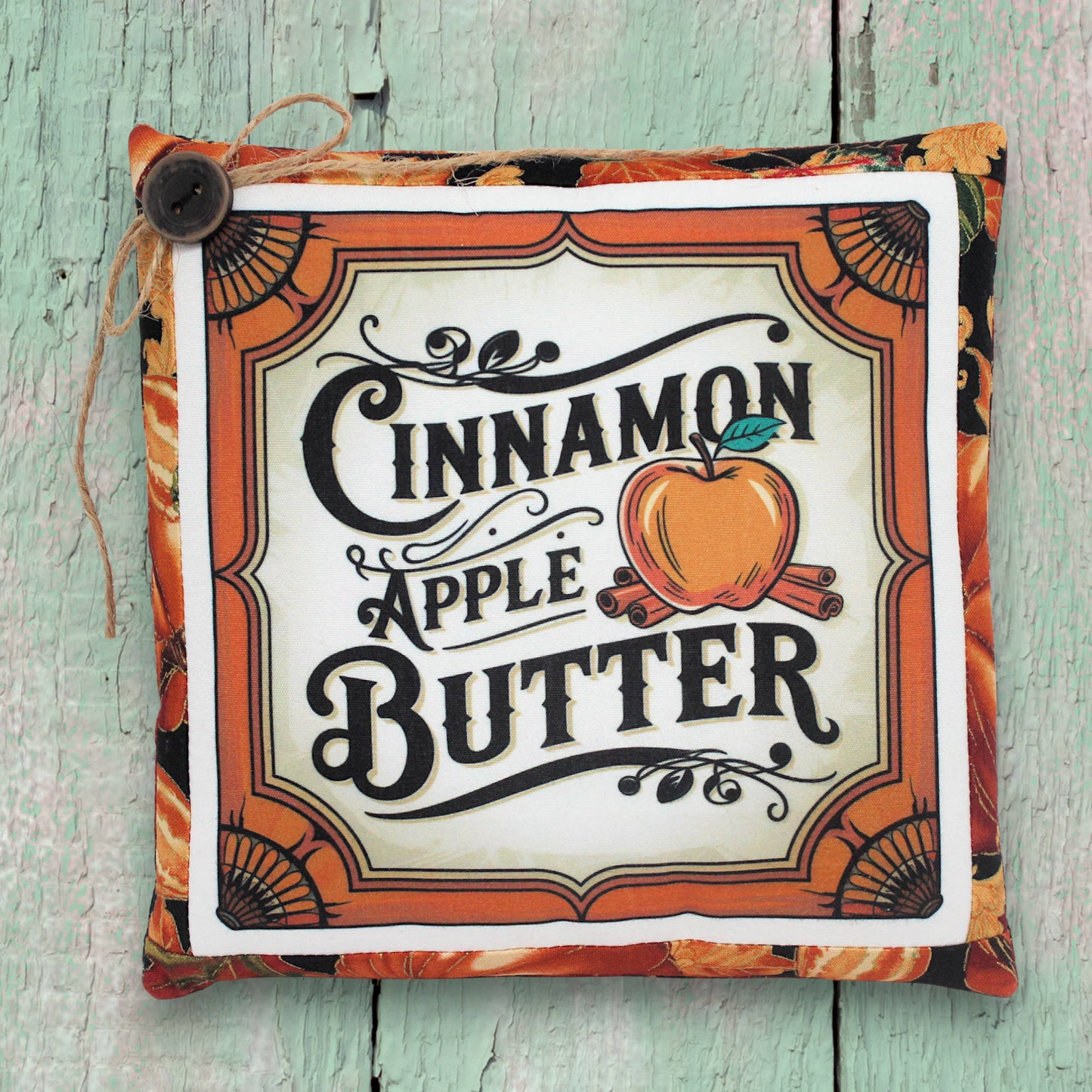 Small decorative pillow with a colorful cinnamon apple butter design for autumn decorating