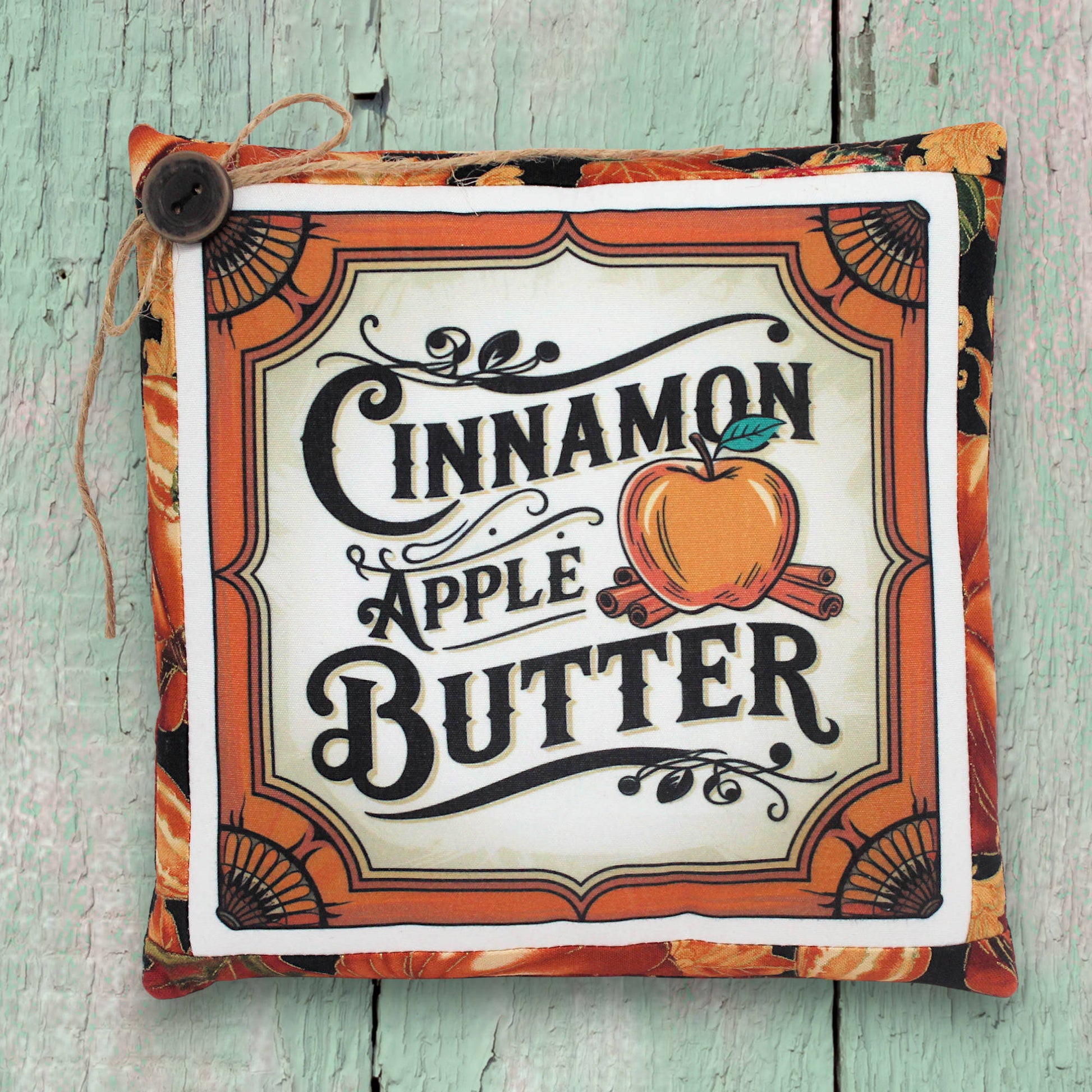 Small decorative pillow with a colorful cinnamon apple butter design for autumn decorating