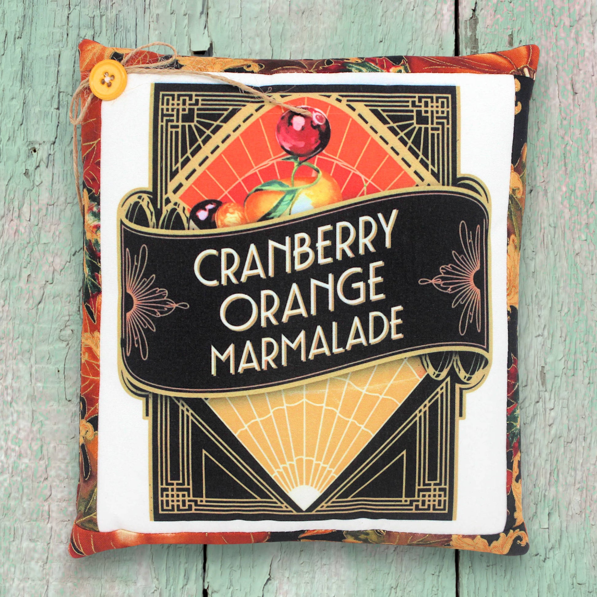 Small decorative pillow with a vintage-style art deco cranberry orange marmalade design for autumn decoratiing