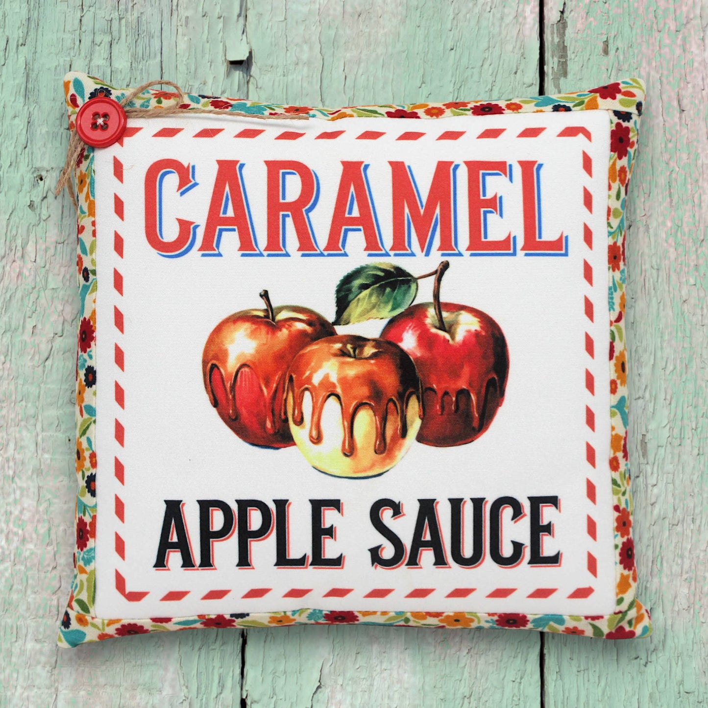 Small decorative pillow featuring a colorful caramel apple sauce design