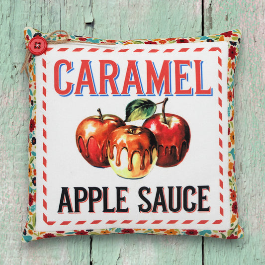 Small decorative pillow featuring a colorful caramel apple sauce design