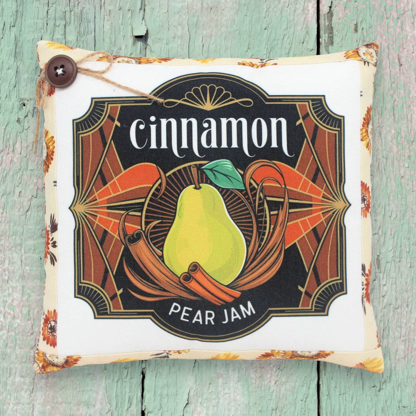 Small decorative pillow featuring a colorful art deco cinnamon pear jam design