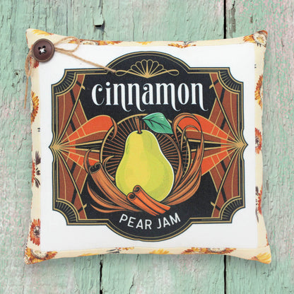 Small decorative pillow featuring a colorful art deco cinnamon pear jam design