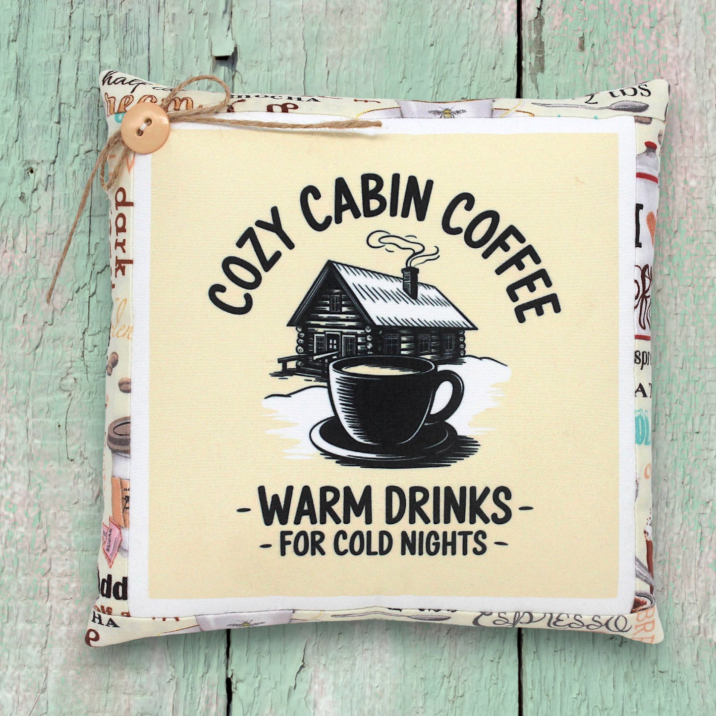Small decorative pillow tuck with a cozy cabin coffee design