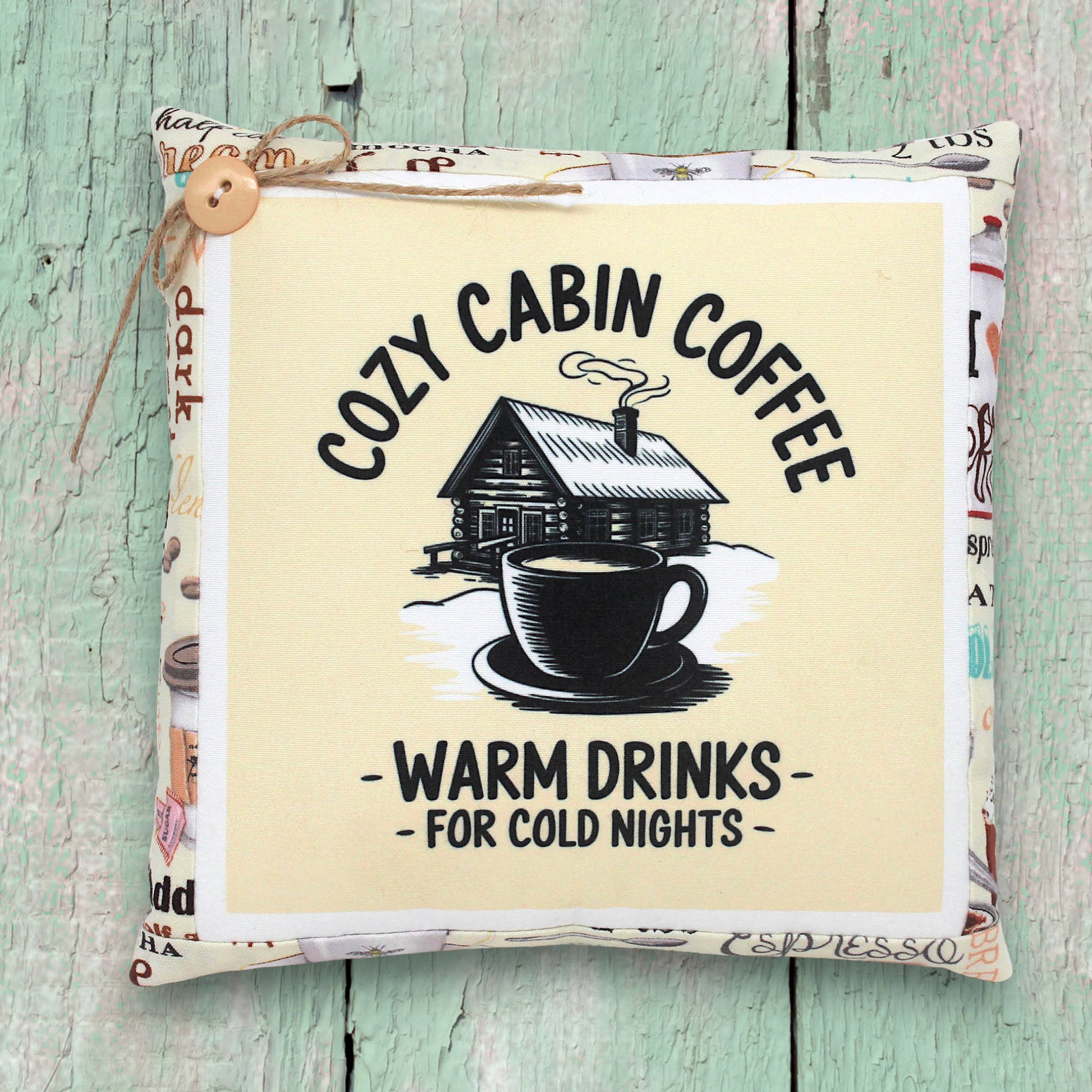 Small decorative pillow tuck with a cozy cabin coffee design