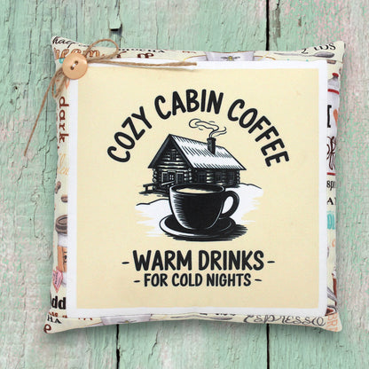 Small decorative pillow tuck with a cozy cabin coffee design