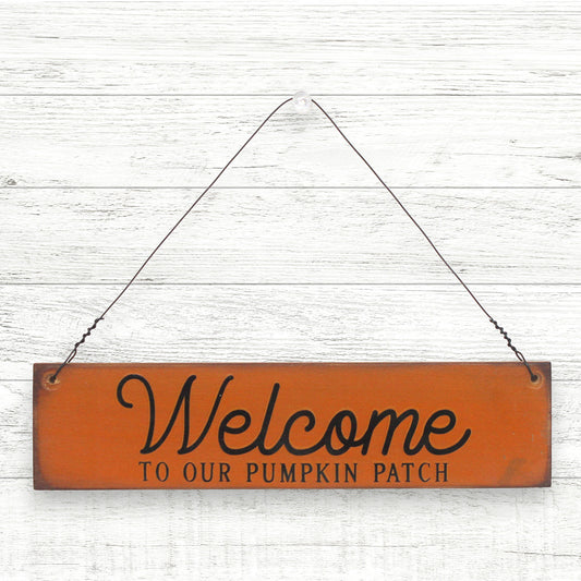 Small distressed handcrafted wooden sign which reads 'welcome to our pumpkin patch'