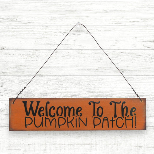 Small distressed wooden handcrafted sign which reads 'welcome to the pumpkin patch'