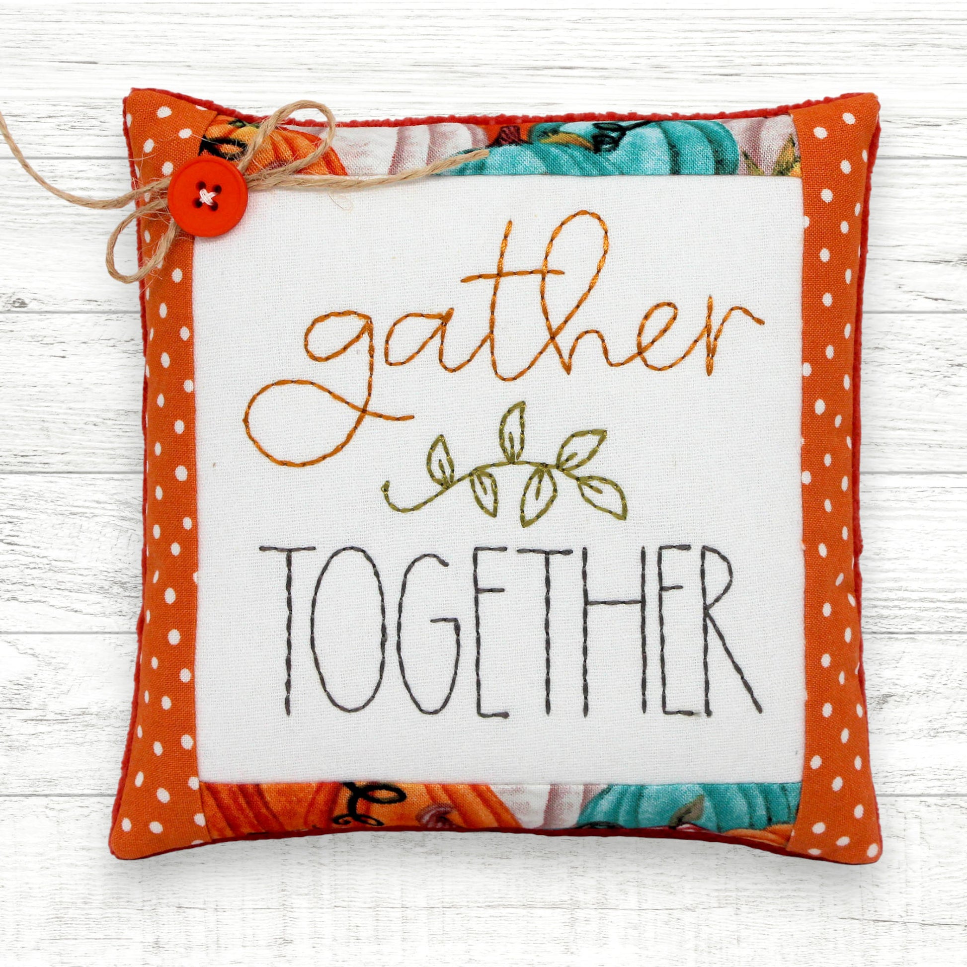 Handcrafted mini pillow embroidered with 'gather together'