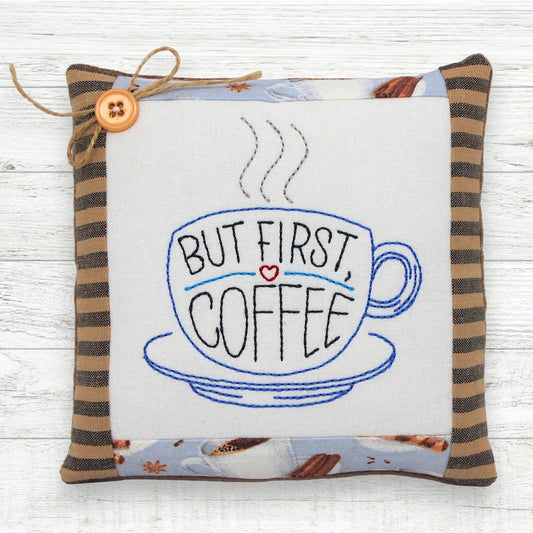 Handmade mini pillow embroidered with a steaming cup of coffee and the text 'but first, coffee'