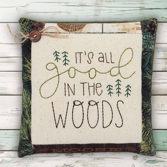 Miniature embroidered cupboard tuck pillow which reads 'it's all good in the woods'